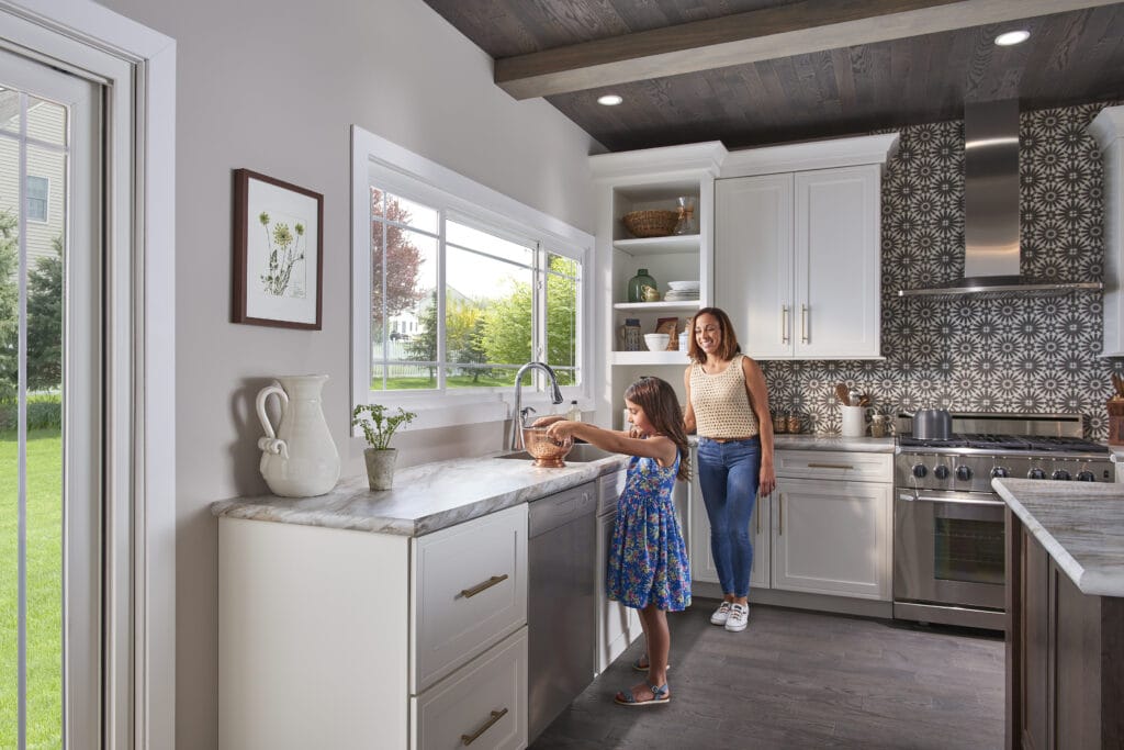 mother and daughter preparing food in a kitchen