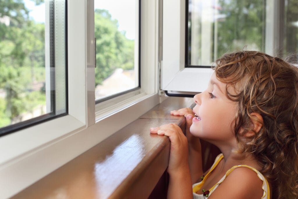 young girl looking out the window